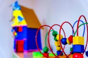Colourful bead maze and toy house in the toddler play area at Balloon Nursery, Sharjah